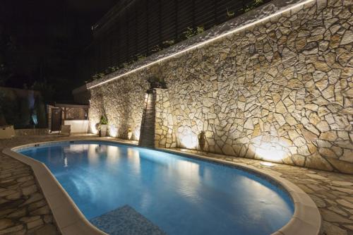 Modern outdoor private swimming pool at night